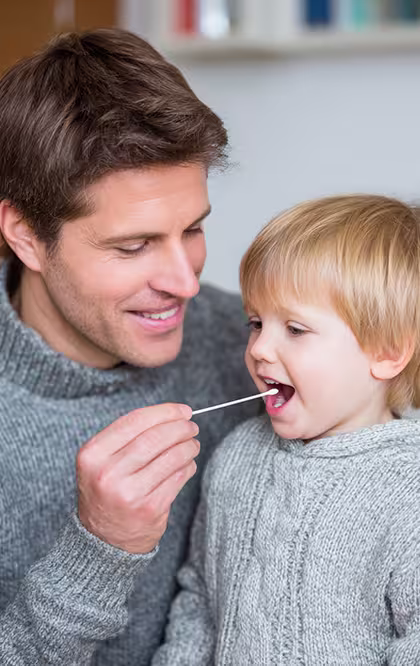 Father giving his son a DNA test